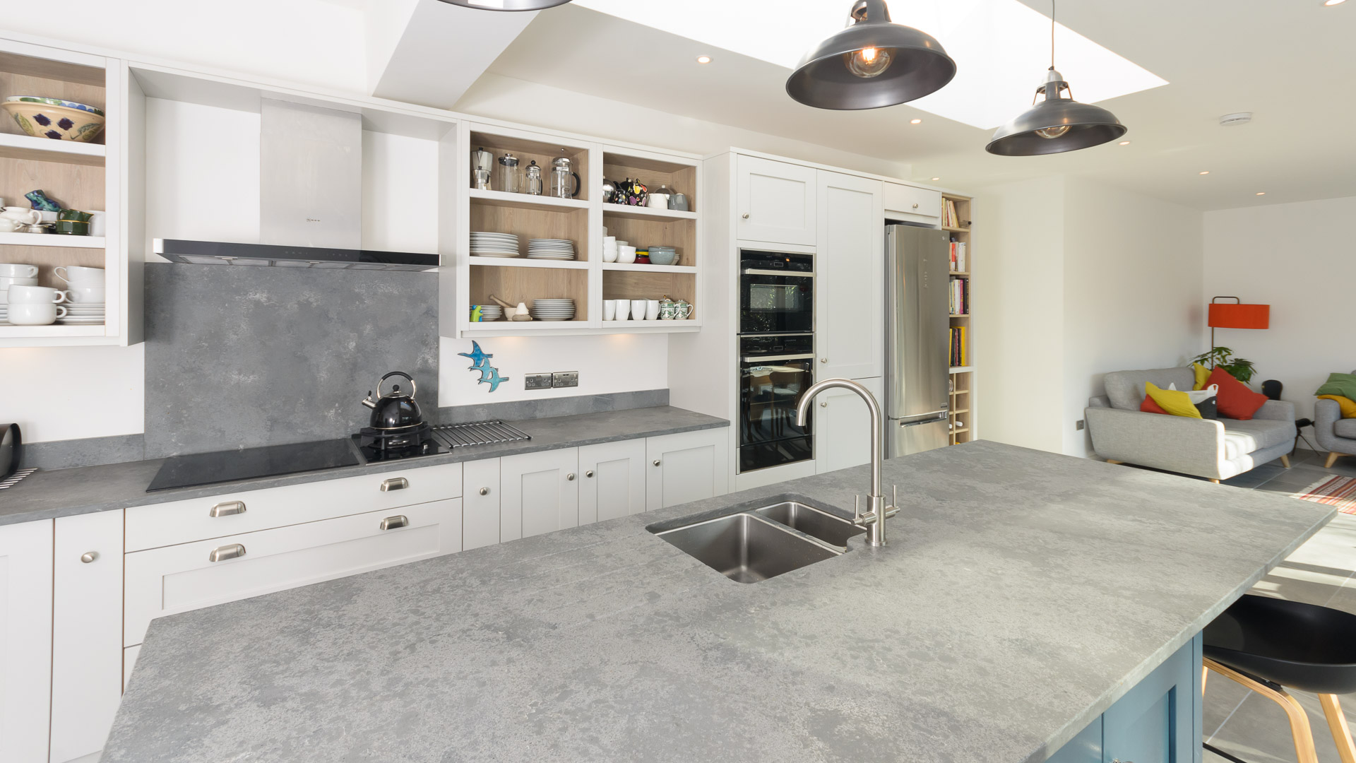 Grey Concrete Quartz worktop with double bowl sink cut-out and chrome tap in a bright modern kitchen