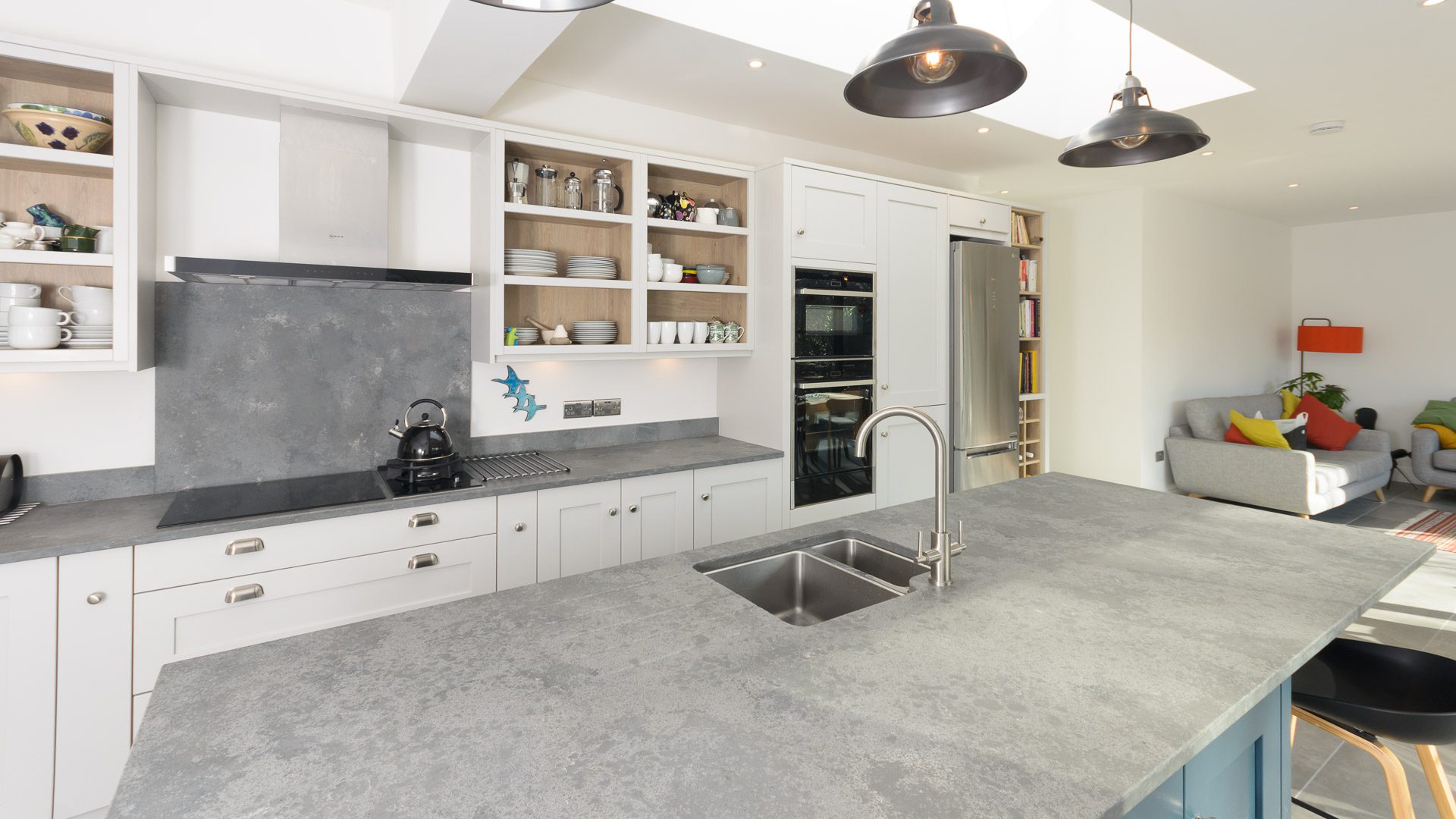 Grey Concrete Quartz worktop with double bowl sink cut-out and chrome tap in a bright modern kitchen