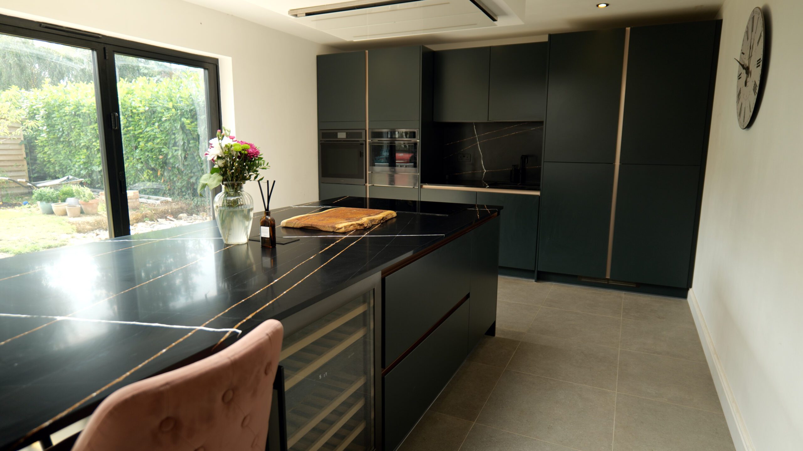 Sahara Noir Quartz island and perimeter worktops in a modern kitchen showing polished black surface with gold-toned lines and white veining