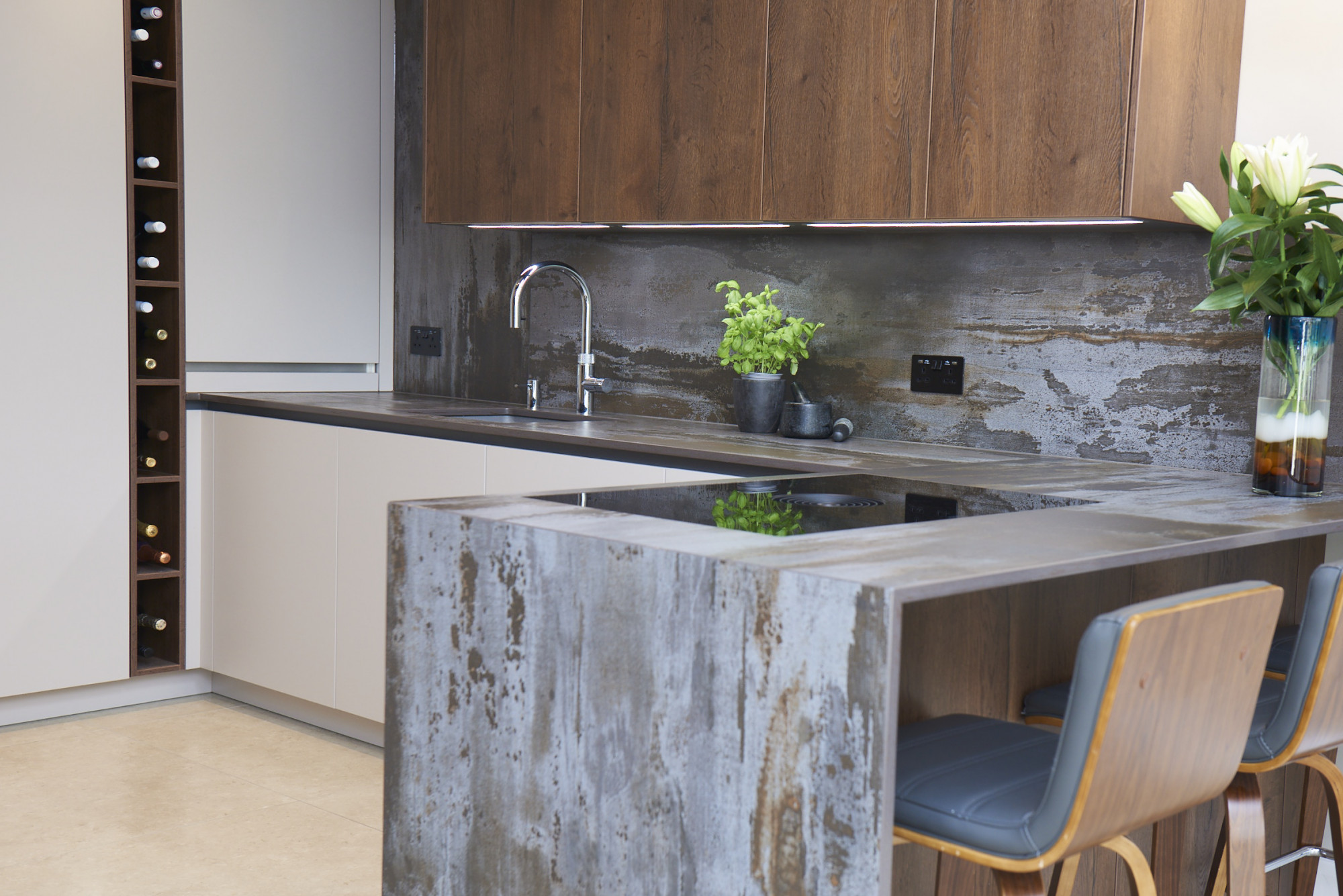 Trilium Porcelain worktop and waterfall island in a modern kitchen with matching splashback and sink run