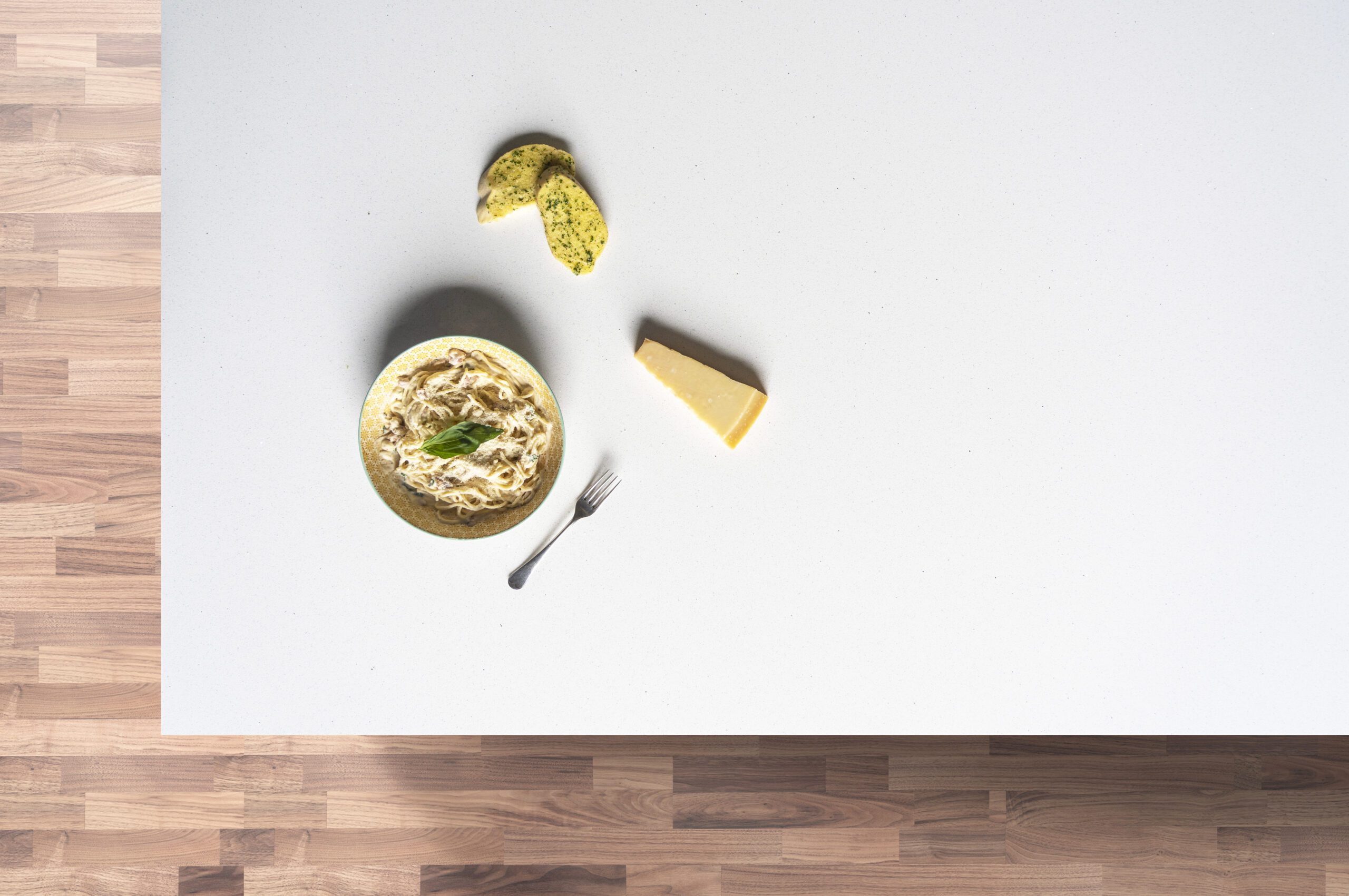Aspen Shimmer Quartz worktop flat lay with food items on a wooden surface