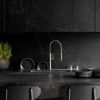 Kelya Porcelain dark worktop run with integrated sink, chrome tap and matching full height splashback