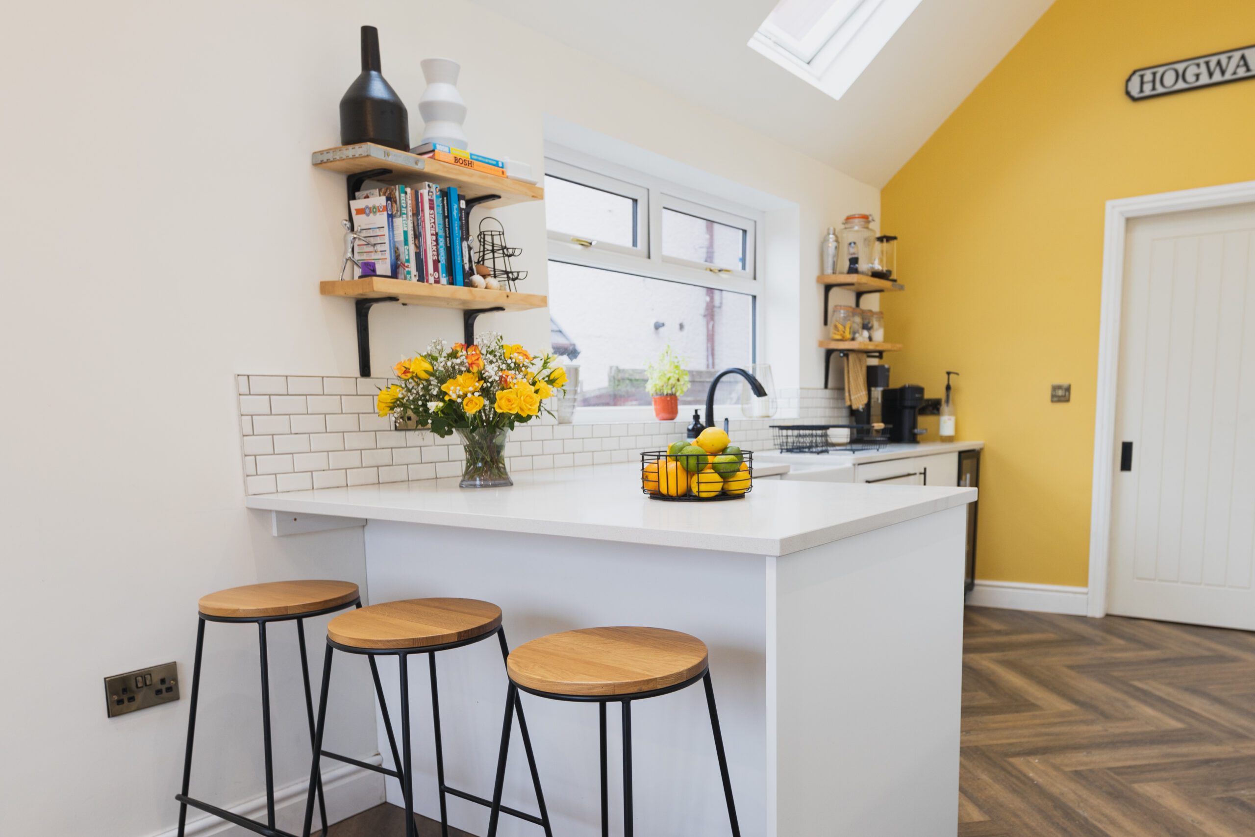 Breakfast bar with Ice White Quartz worktop and seating, showing a smooth white surface finish