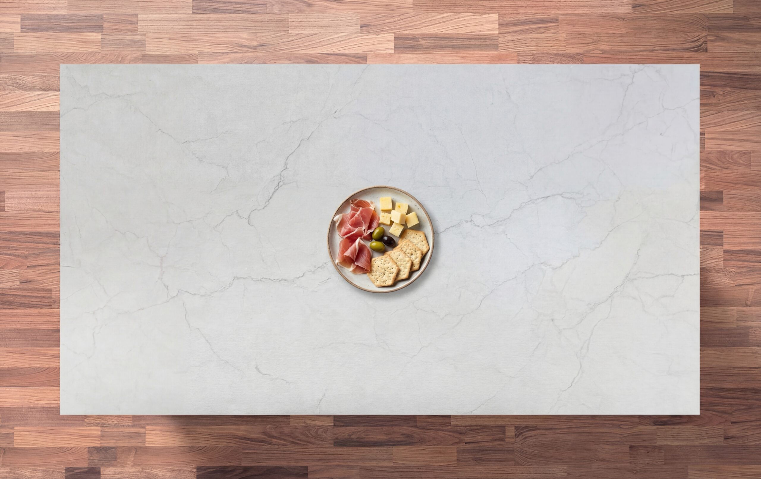 Statuario Venato Porcelain worktop slab shown from above with soft grey veining and a styled bowl