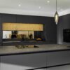 Wide view of Laurent Porcelain worktop with gold veining on a large kitchen run, featuring a flush induction hob and pendant lighting.