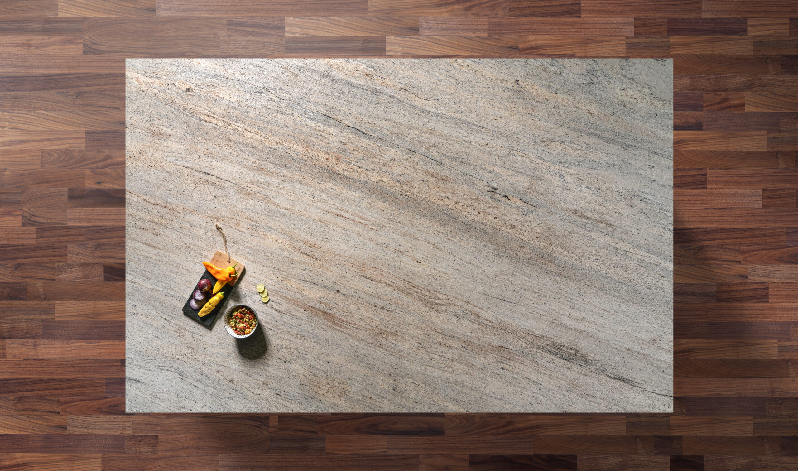Overhead view of an Ivory Fantasy Granite island worktop with natural veining, photographed from above with a small styled tray on the corner.