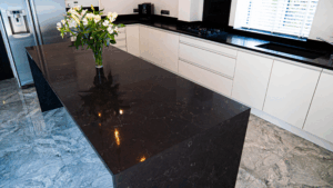 Emperor Black Quartz island worktop with polished black surface and subtle veining in a modern kitchen setting