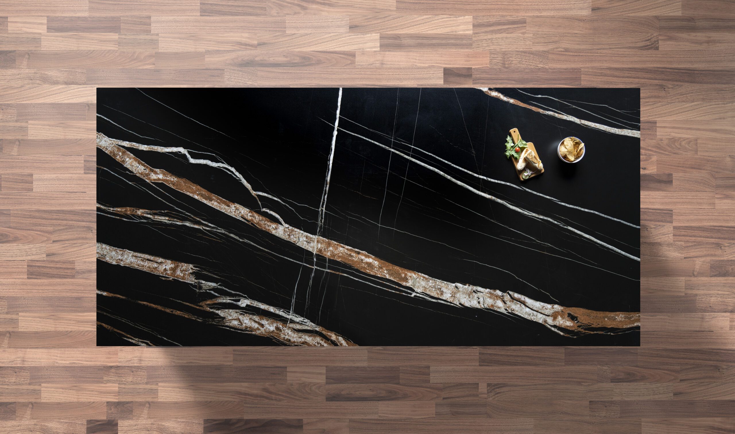 Noir St Laurent Porcelain worktop slab shown from above with black base and bold gold veining on a wood background