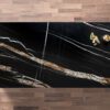 Noir St Laurent Porcelain worktop slab shown from above with black base and bold gold veining on a wood background