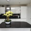 Modern kitchen with a Black Starlight Quartz island worktop showing a deep black surface with subtle sparkle