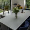 Modern kitchen with Carrara Quartz worktops and light grey veining