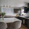 Wide view of a modern kitchen with Imperial White Quartz worktops on the perimeter and island