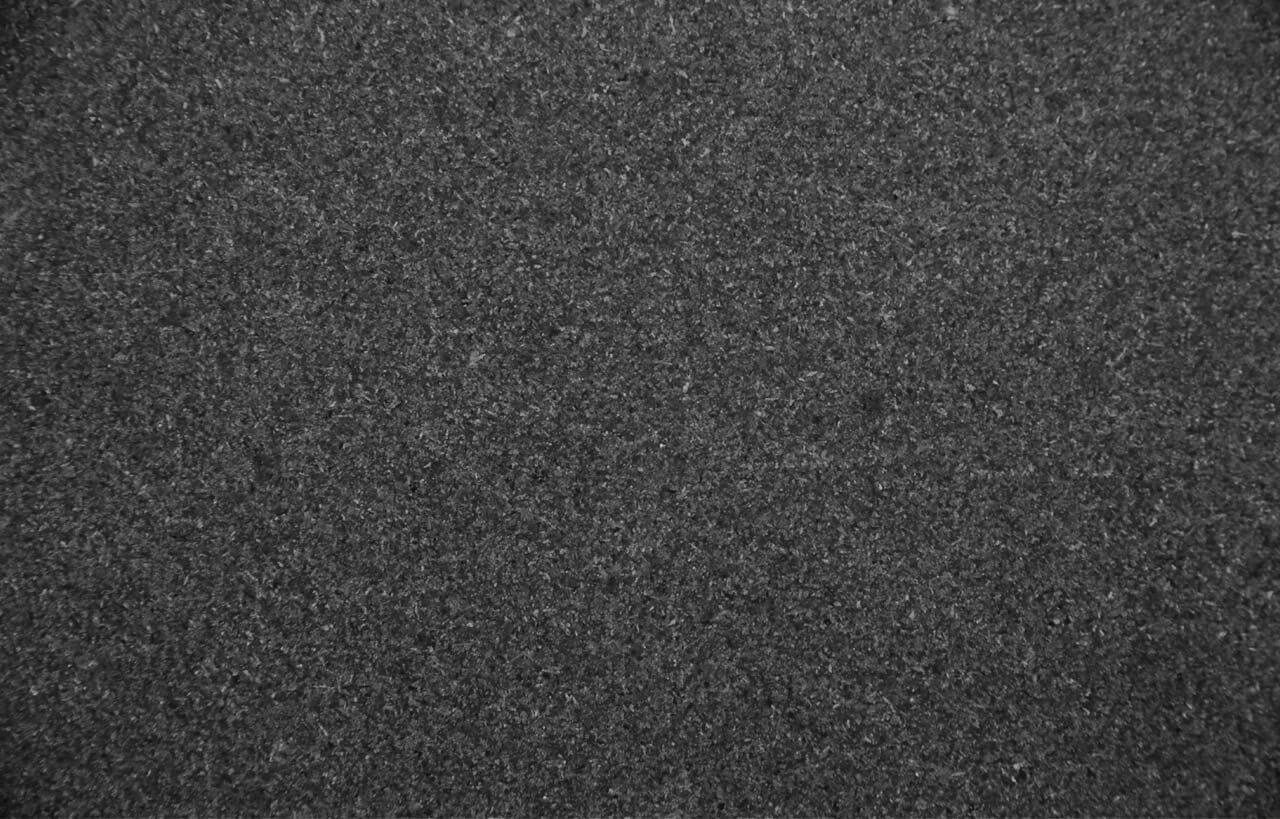 Close up slab photo of honed Absolute Black Granite showing a deep black tone with a smooth matte finish and subtle natural texture.