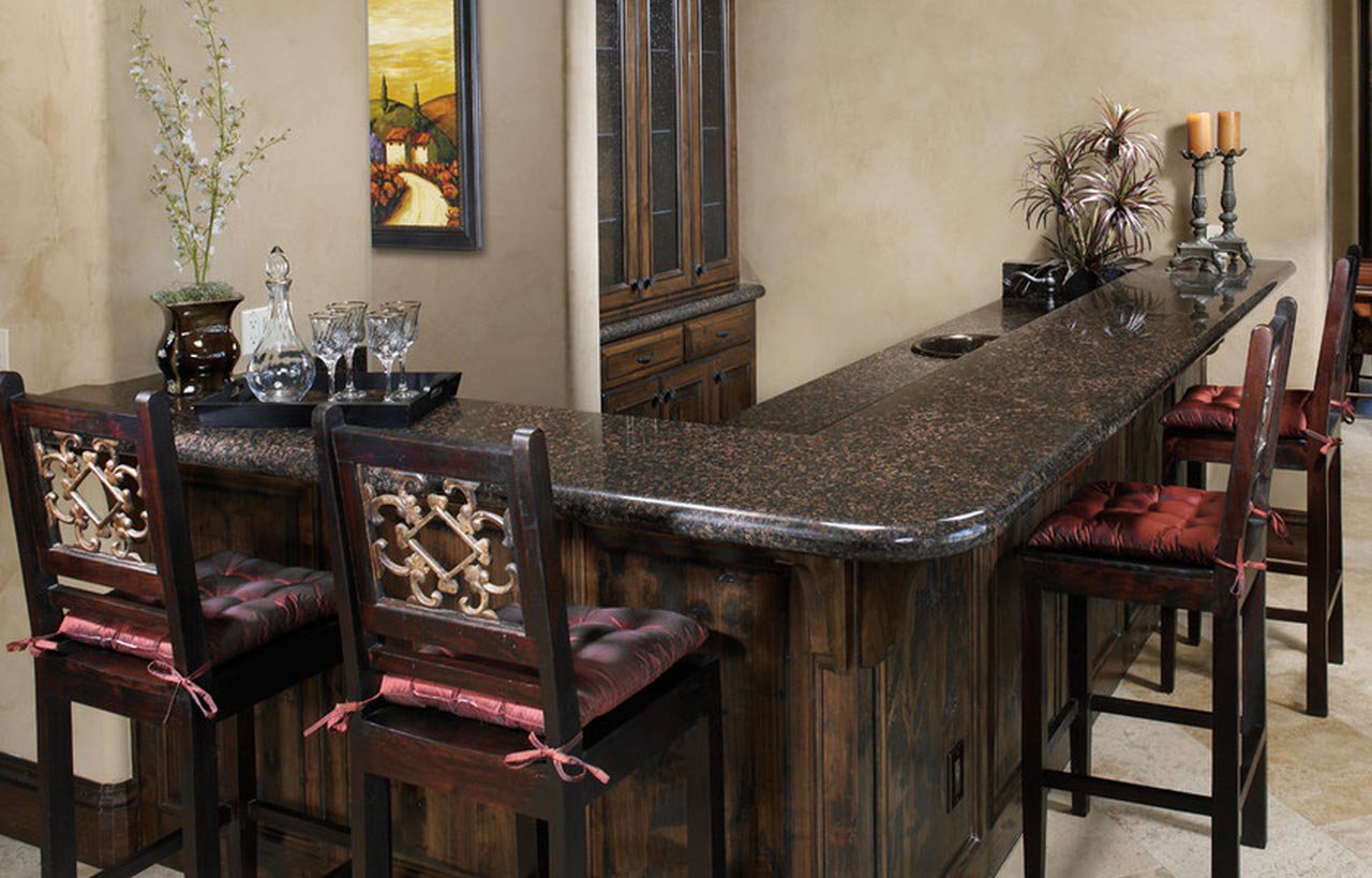 Bar area view with Tan Brown Granite worktop, showing the polished Granite surface on a curved edge with bar stools and ambient lighting.