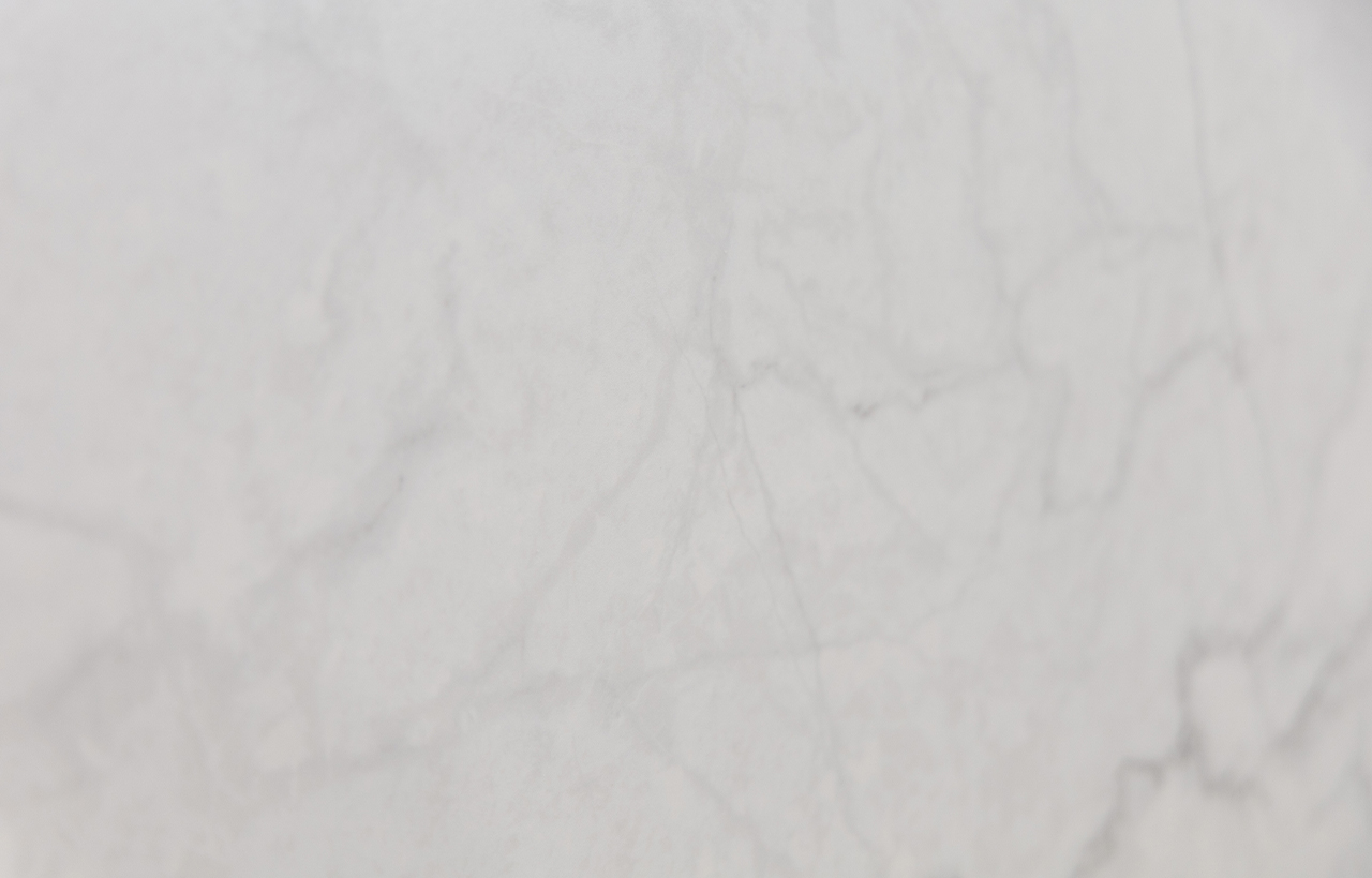Statuario Venato Porcelain close-up with soft, low-contrast veining across a light white surface.
