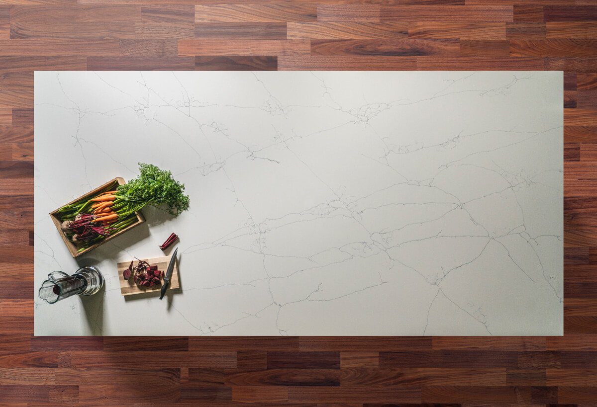 Overhead view of White Macaubus Quartz worktop showing soft grey veining across a bright surface