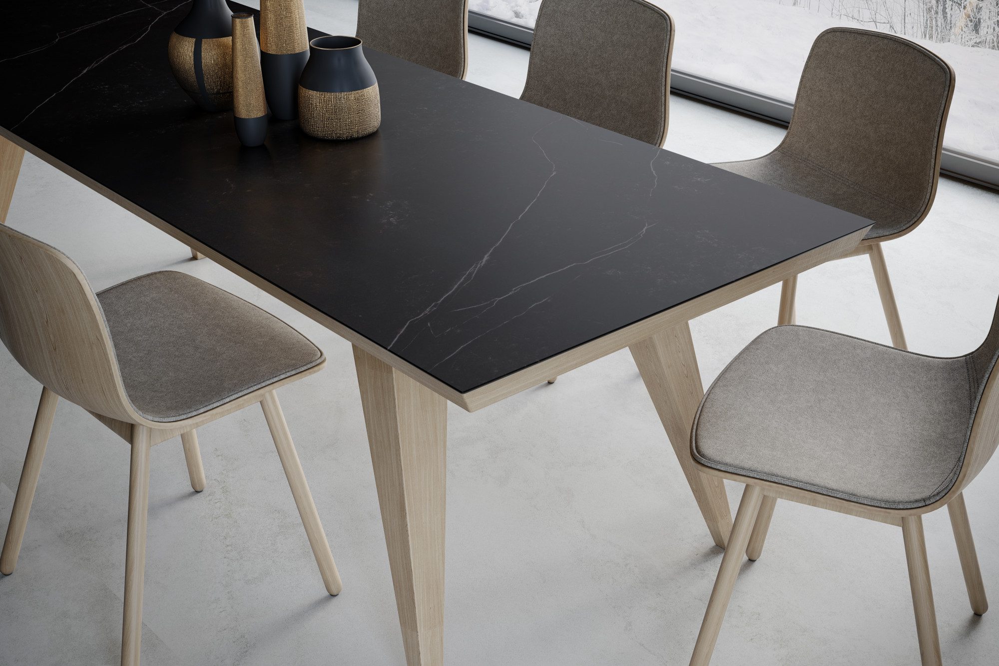 Kelya Porcelain tabletop in deep charcoal with a diagonal white vein, styled with dining chairs