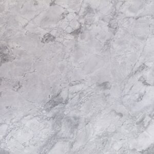 Close up slab photo of Bianco Eclipsia Granite showing soft pale grey clouding and gentle natural movement across a light stone surface.