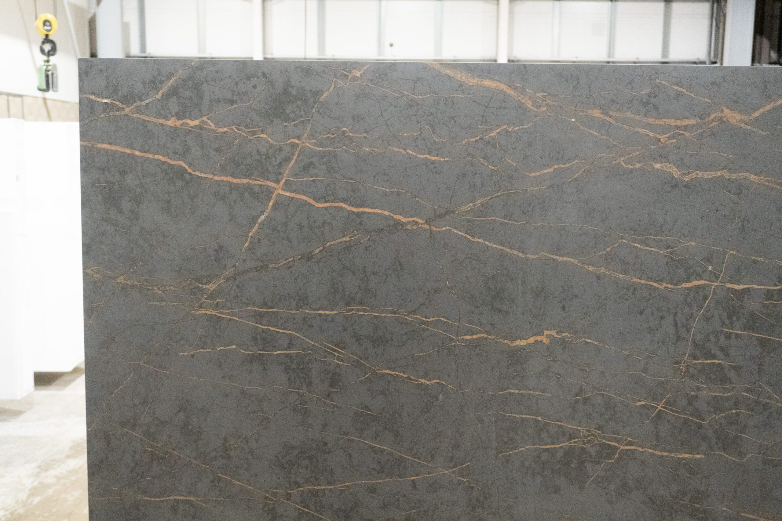 Gold Laurent Porcelain slab face showing fine gold veins spread across a dark grey surface