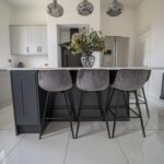 Classic White Quartz breakfast bar island with bar stools, showing a smooth white surface finish