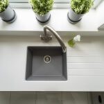 Classic White Quartz sink run with drainer grooves and an inset sink, showing a smooth white finish