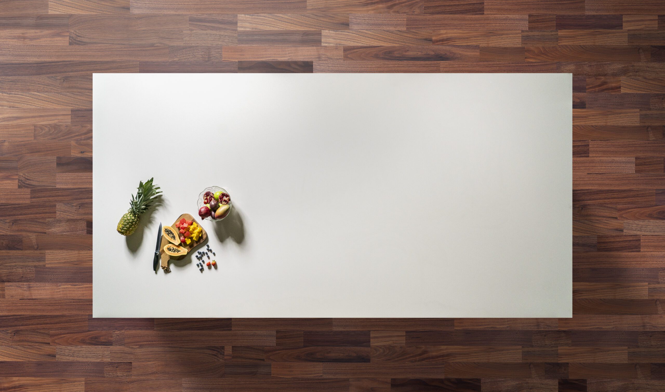 Overhead view of an Imperial White Quartz worktop with a smooth white surface and food prep items